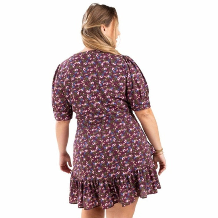 Woman wearing a floral dress on a white background