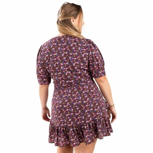 Woman wearing a floral dress on a white background
