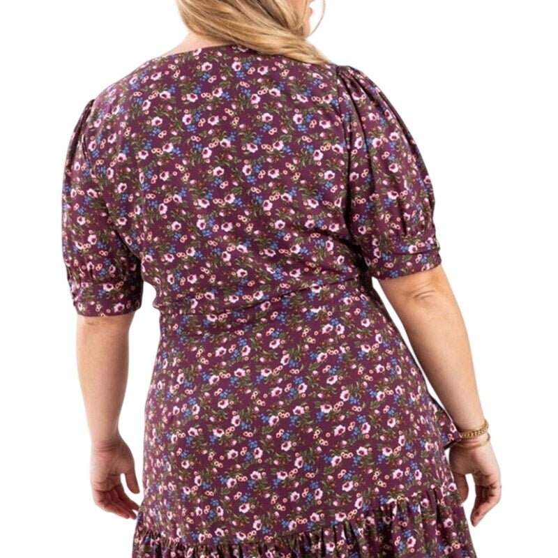 Woman wearing a floral dress with a white background