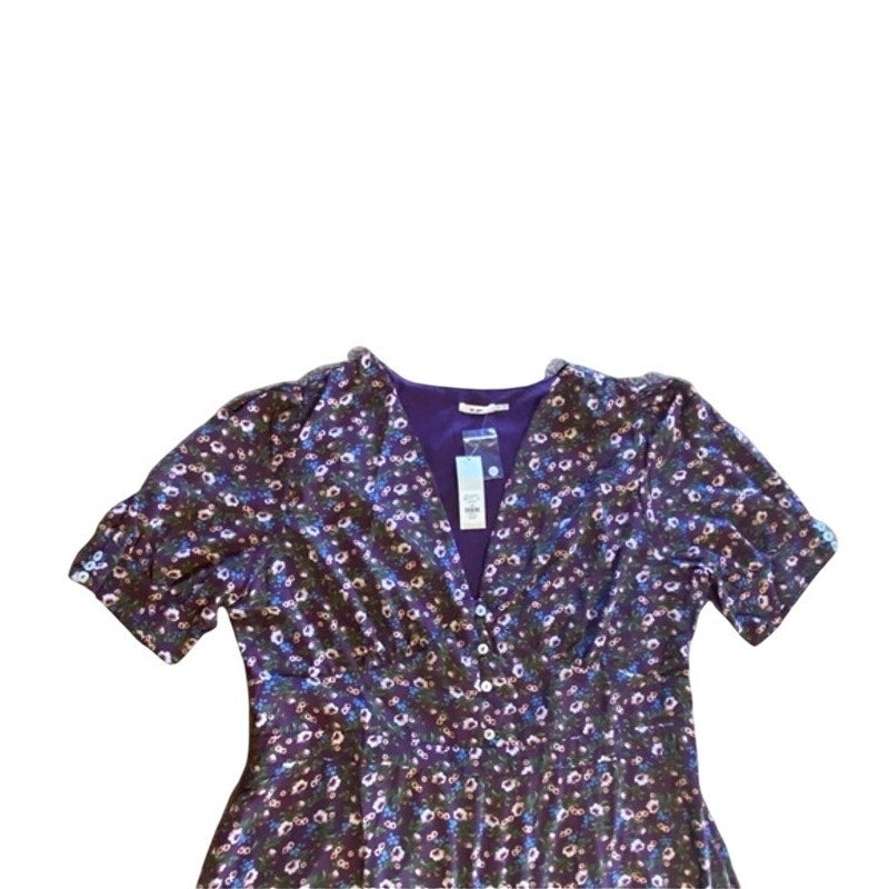 Floral patterned blouse with a tag on a white background