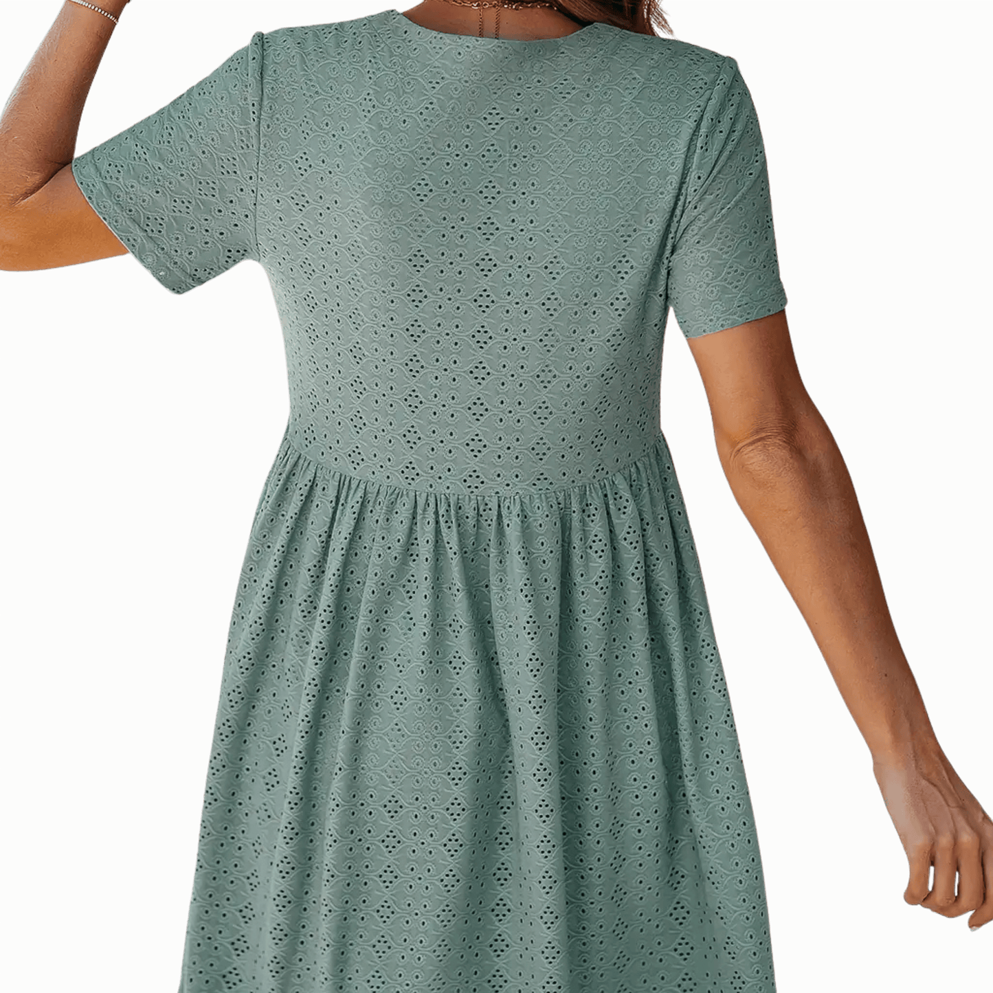 Green dress with short sleeves and a patterned design on a green background
