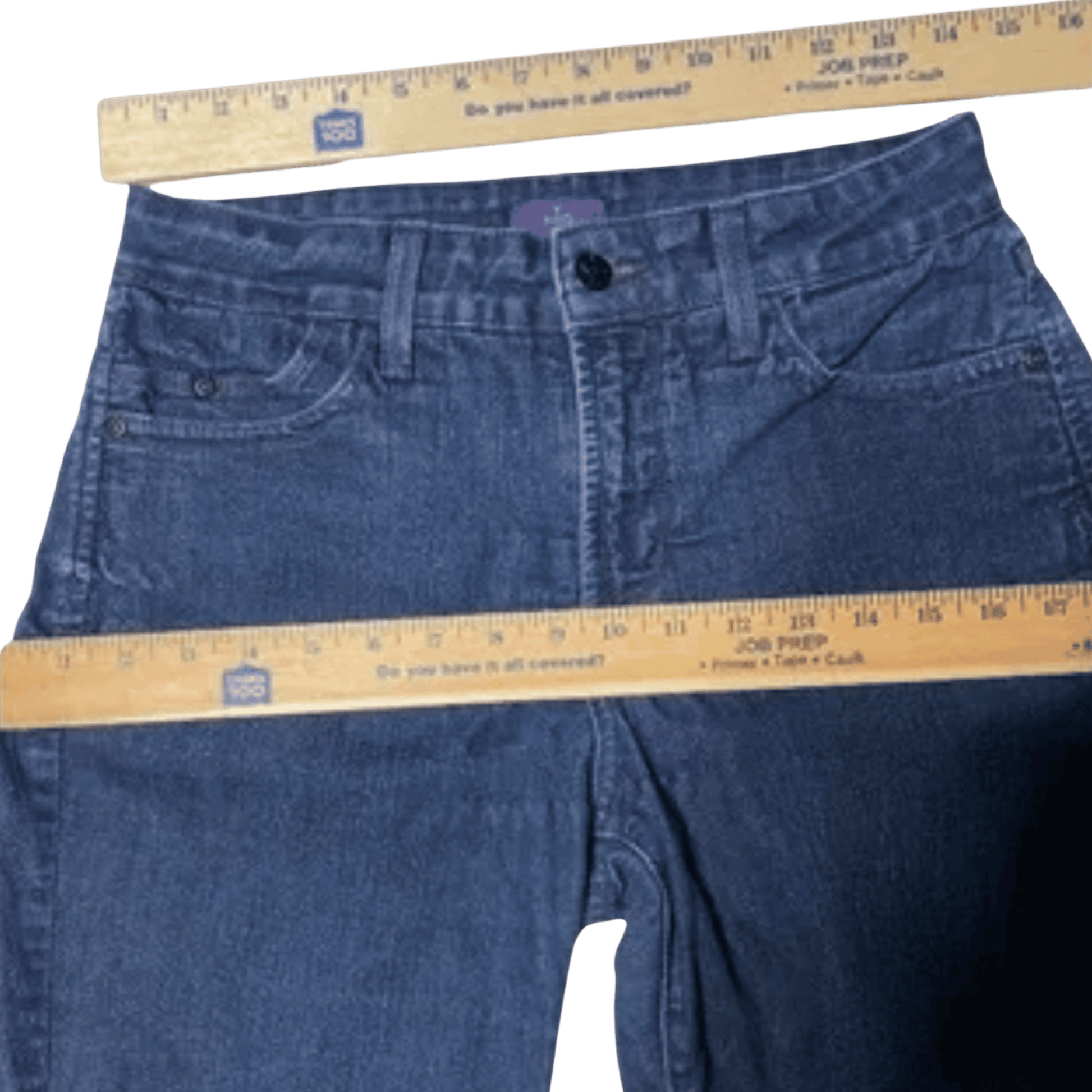 Blue jeans with a ruler for size reference on a transparent background