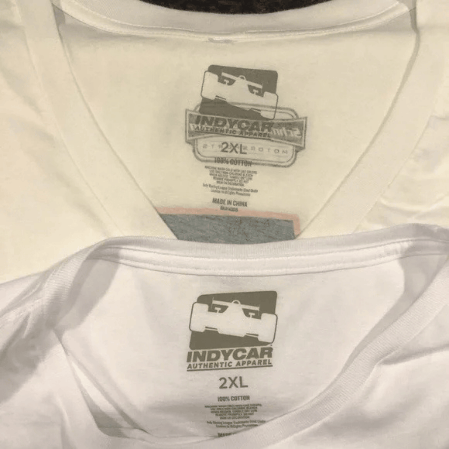 Close-up of a white t-shirt with an Indycar label on the tag.