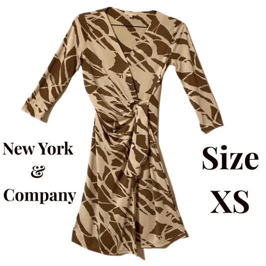 Brown patterned dress on a green background with 'New York & Company' branding and size 'XS' text.
