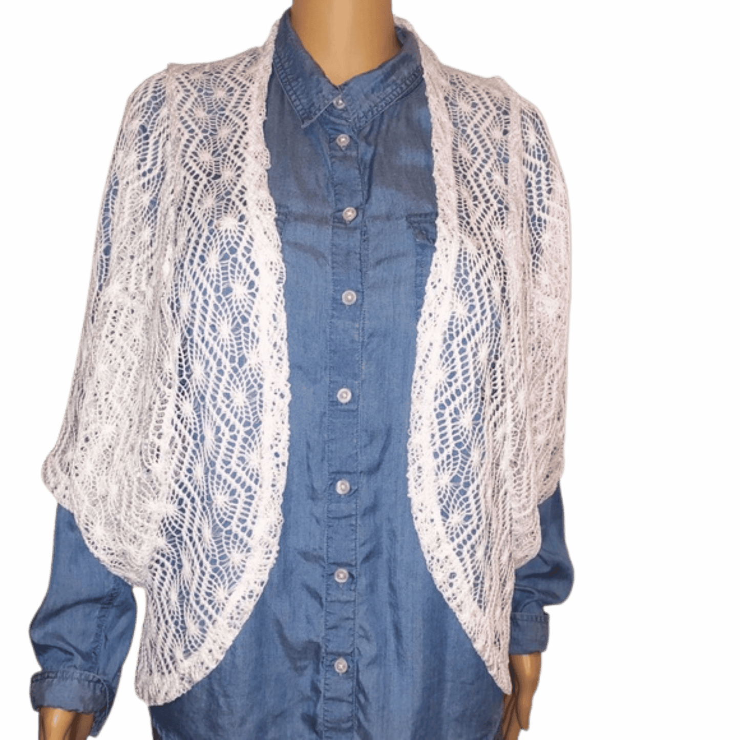 Mannequin wearing a blue shirt with a white lace cardigan on a gray background
