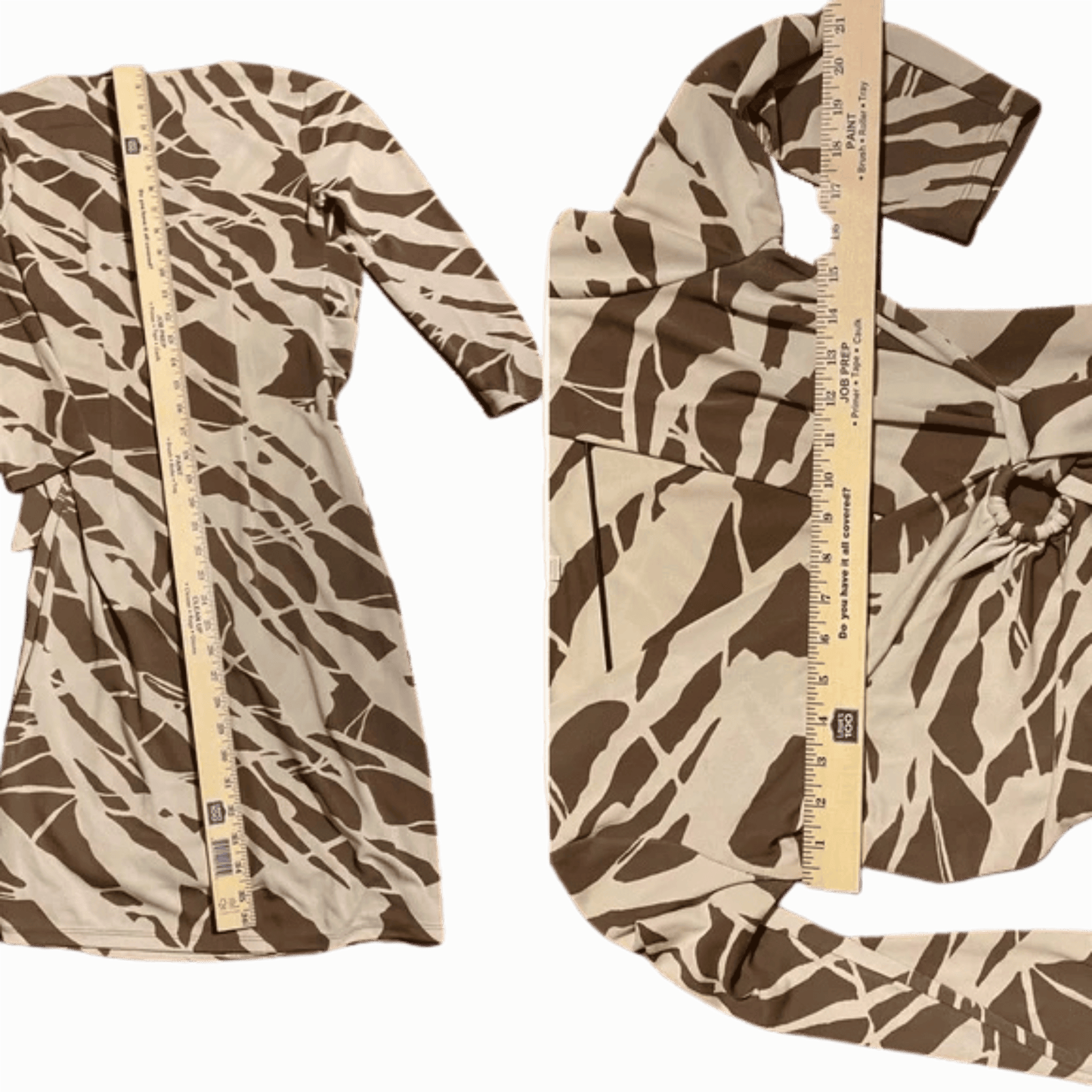 Camouflage-patterned fabric with a ruler for scale on a green background