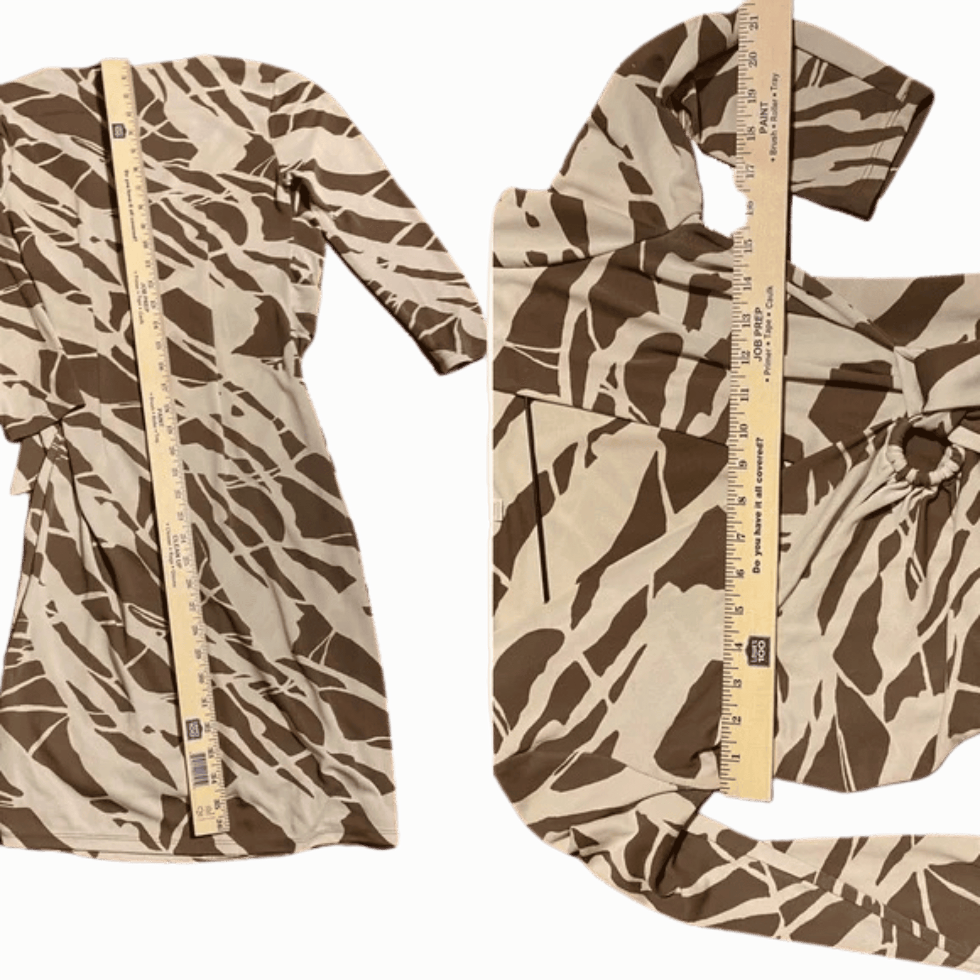 Camouflage-patterned fabric with a ruler for scale on a green background