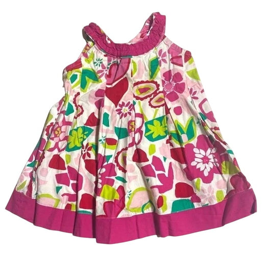 Colorful floral dress with pink trim on a white background