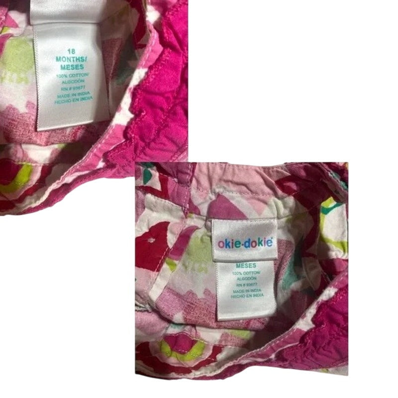Floral-patterned baby outfit with a visible brand label on a white background