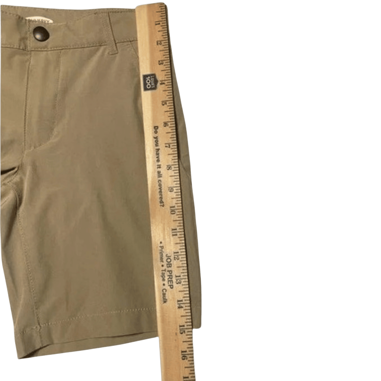Brown shorts with a wooden ruler for size reference on a transparent background