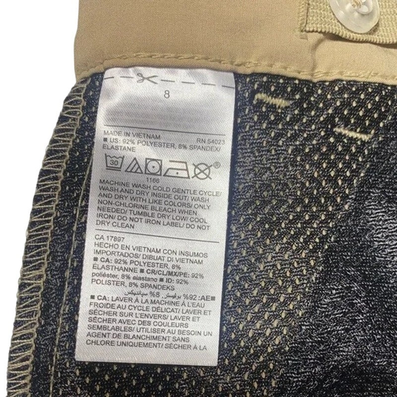 Close-up of a clothing label on denim fabric with visible text and symbols.