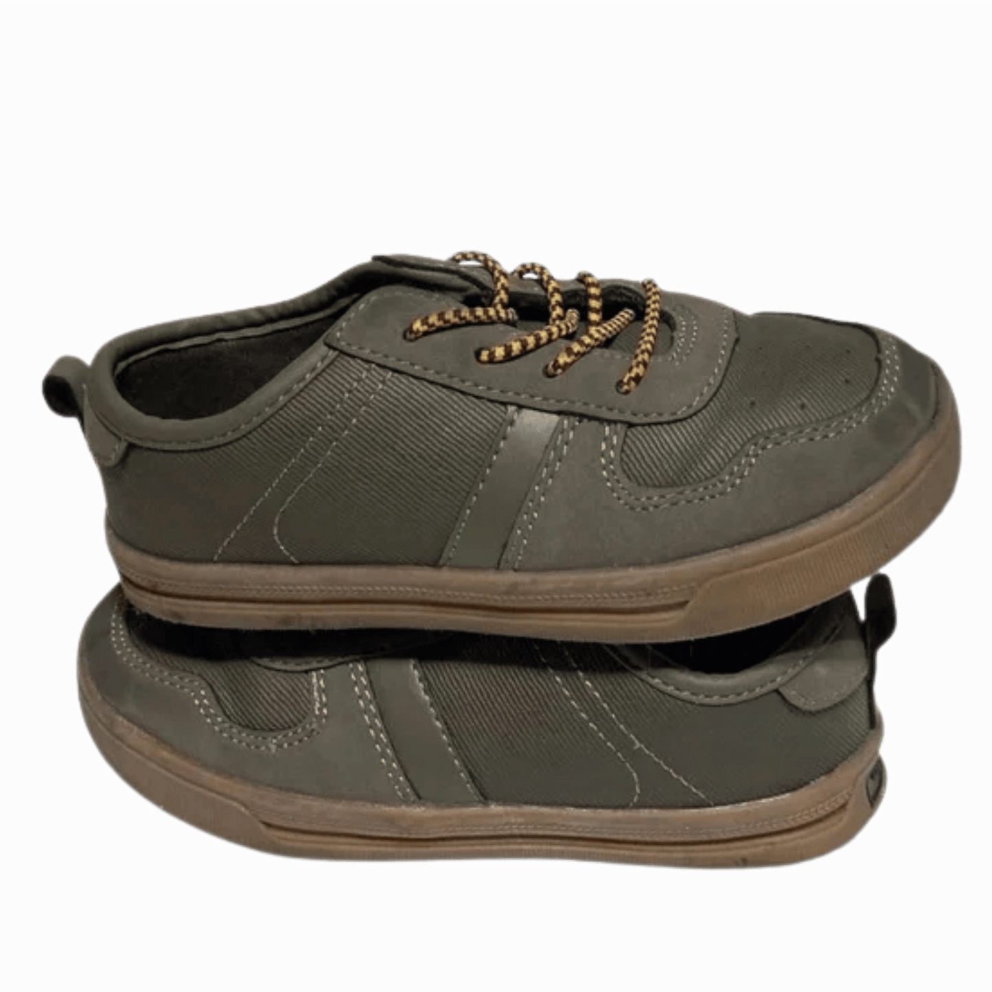 Green sneaker with brown sole on a transparent background