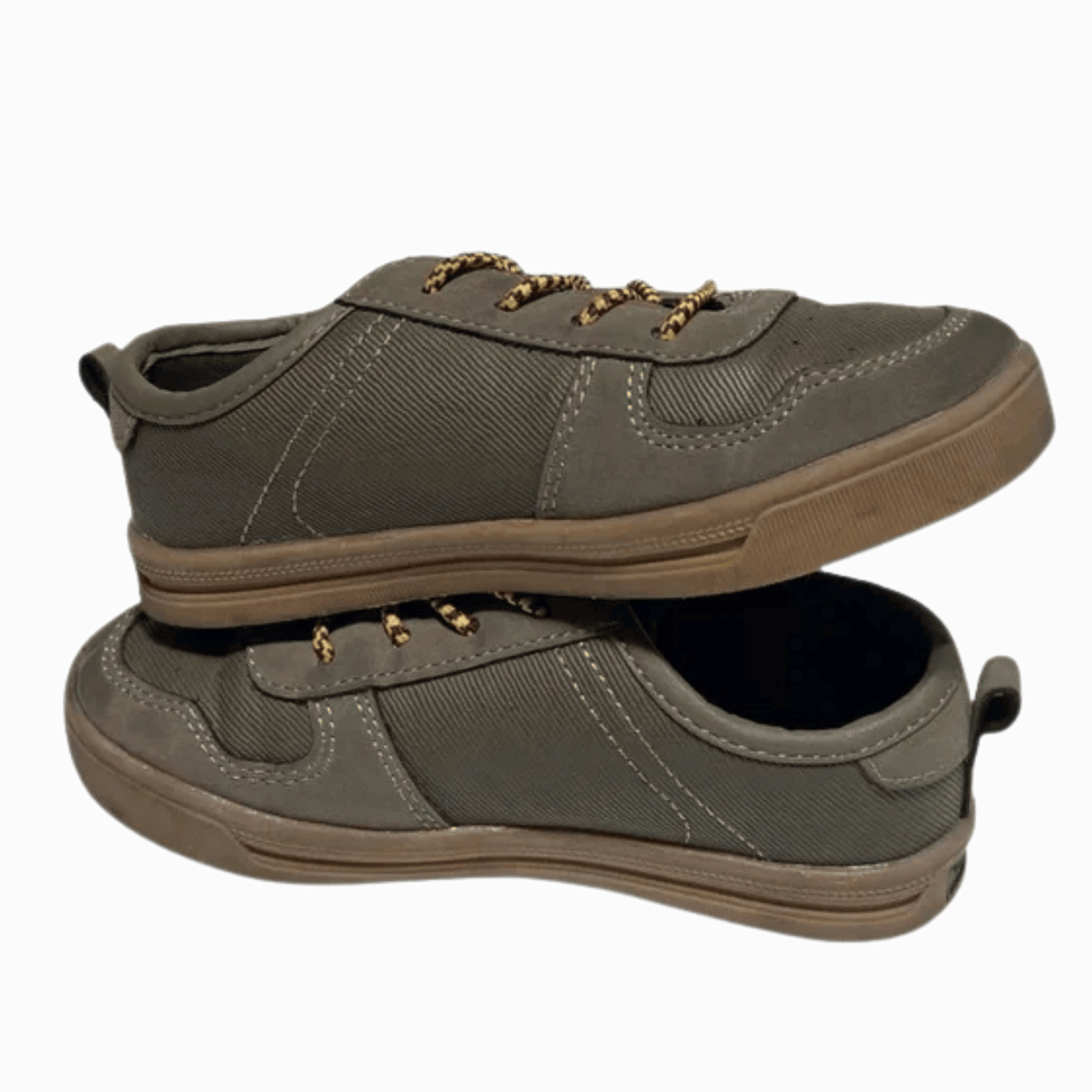 Pair of green casual shoes with brown soles on a gray background