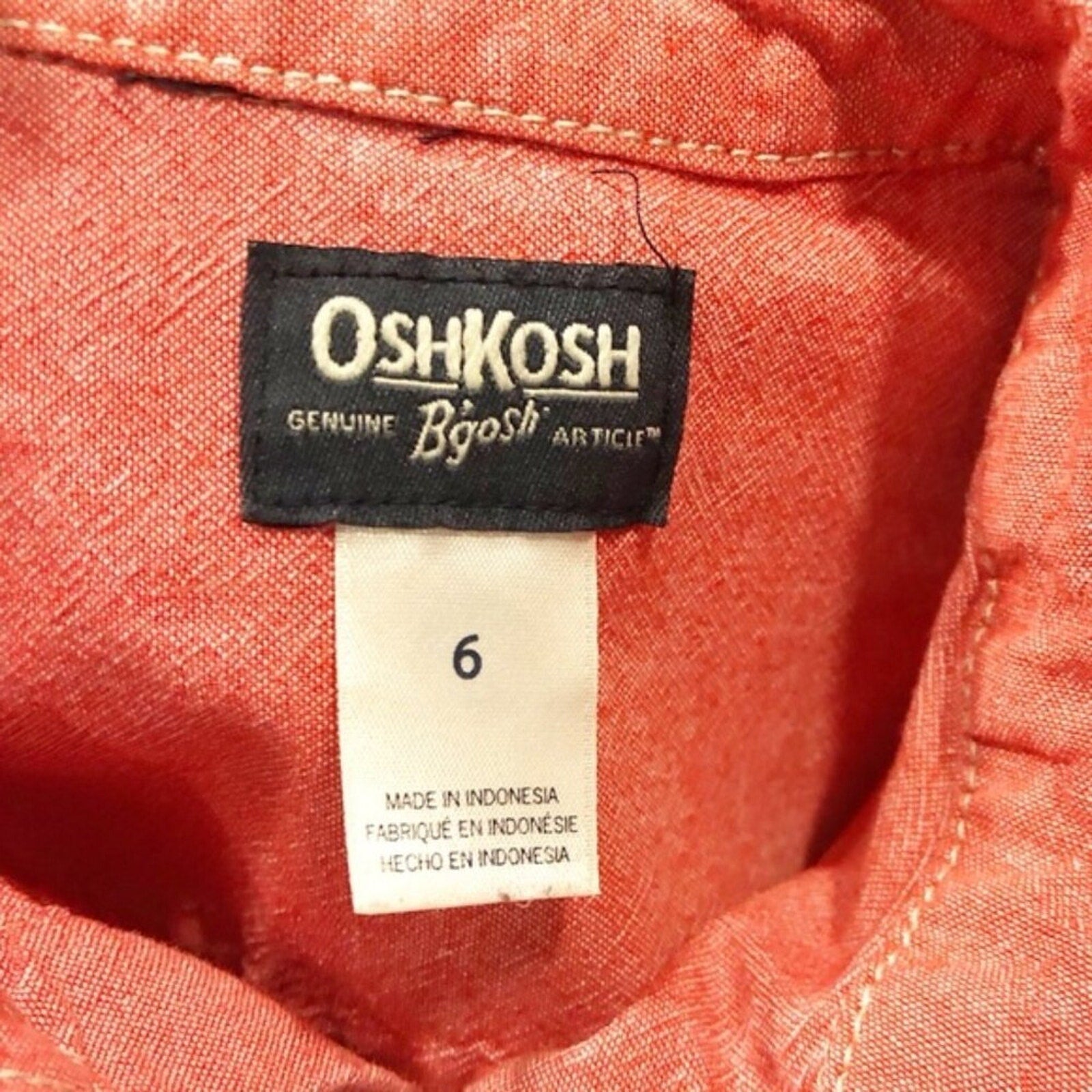 OshKosh label on a red fabric background