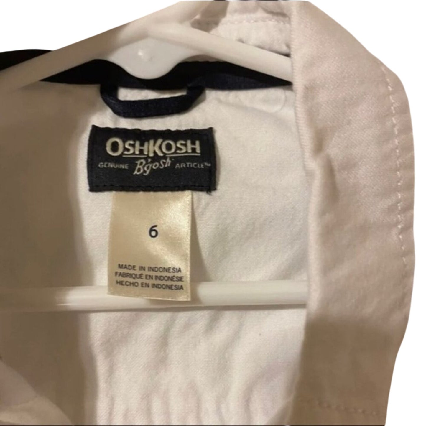 Children's shirt with OshKosh label on a hanger