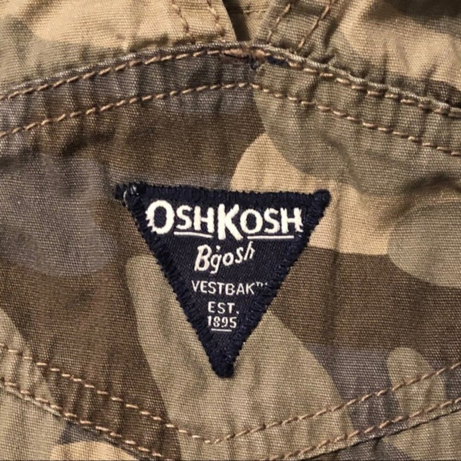 OshKosh Bégot logo on a camouflage jacket