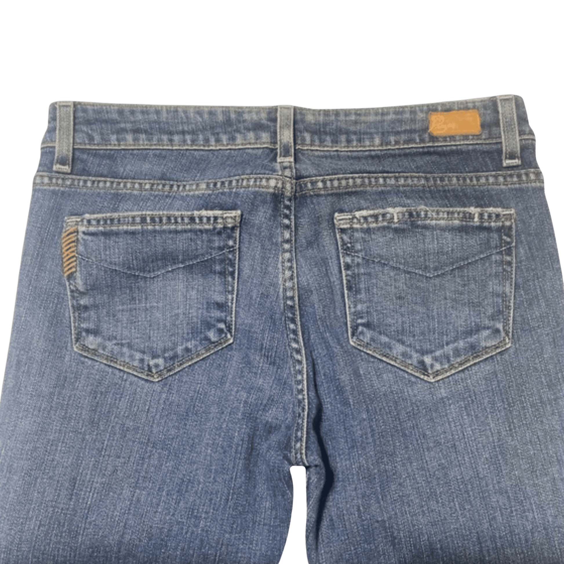 Back view of blue jeans with a brand label on a transparent background