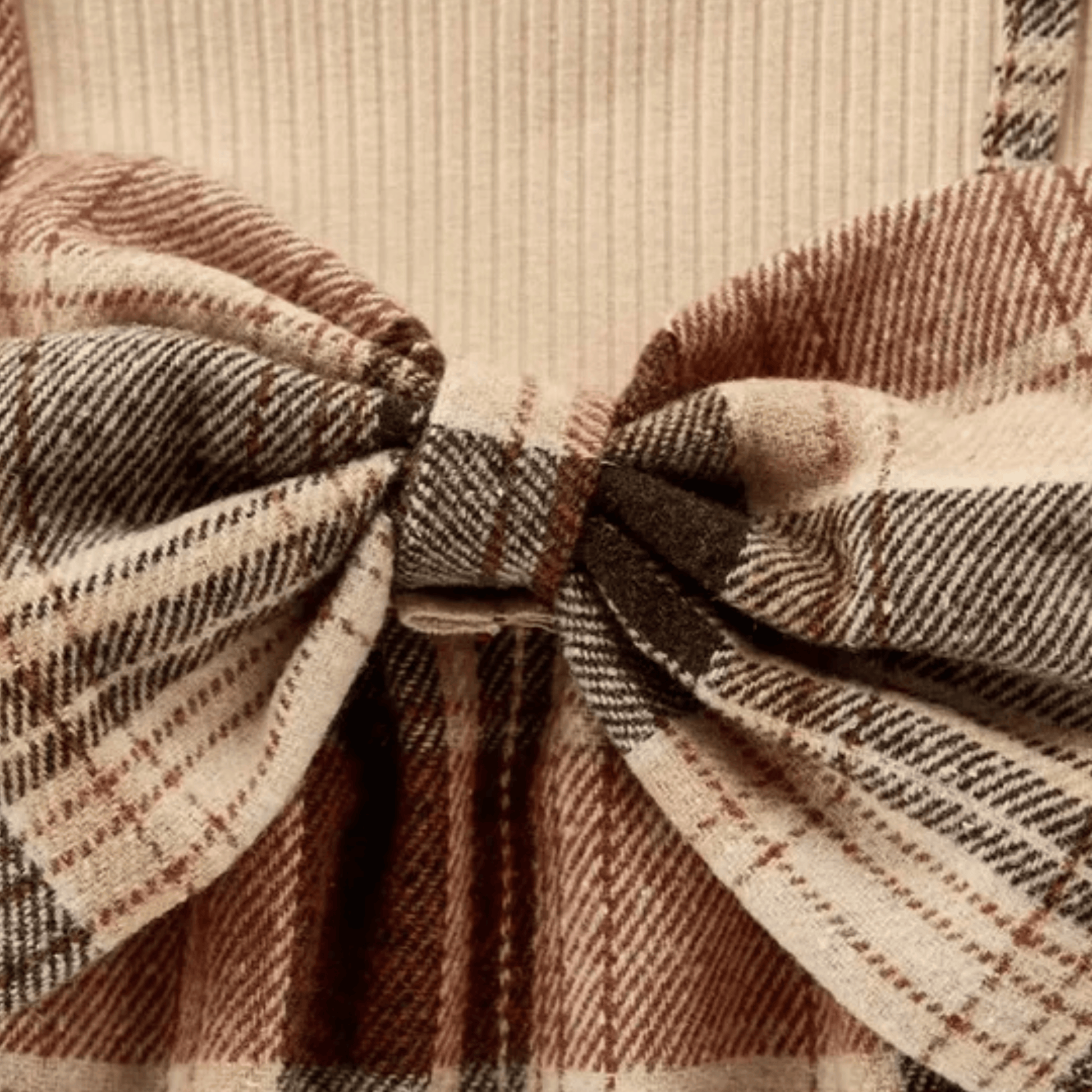 Close-up of a plaid fabric with a prominent bow knot.