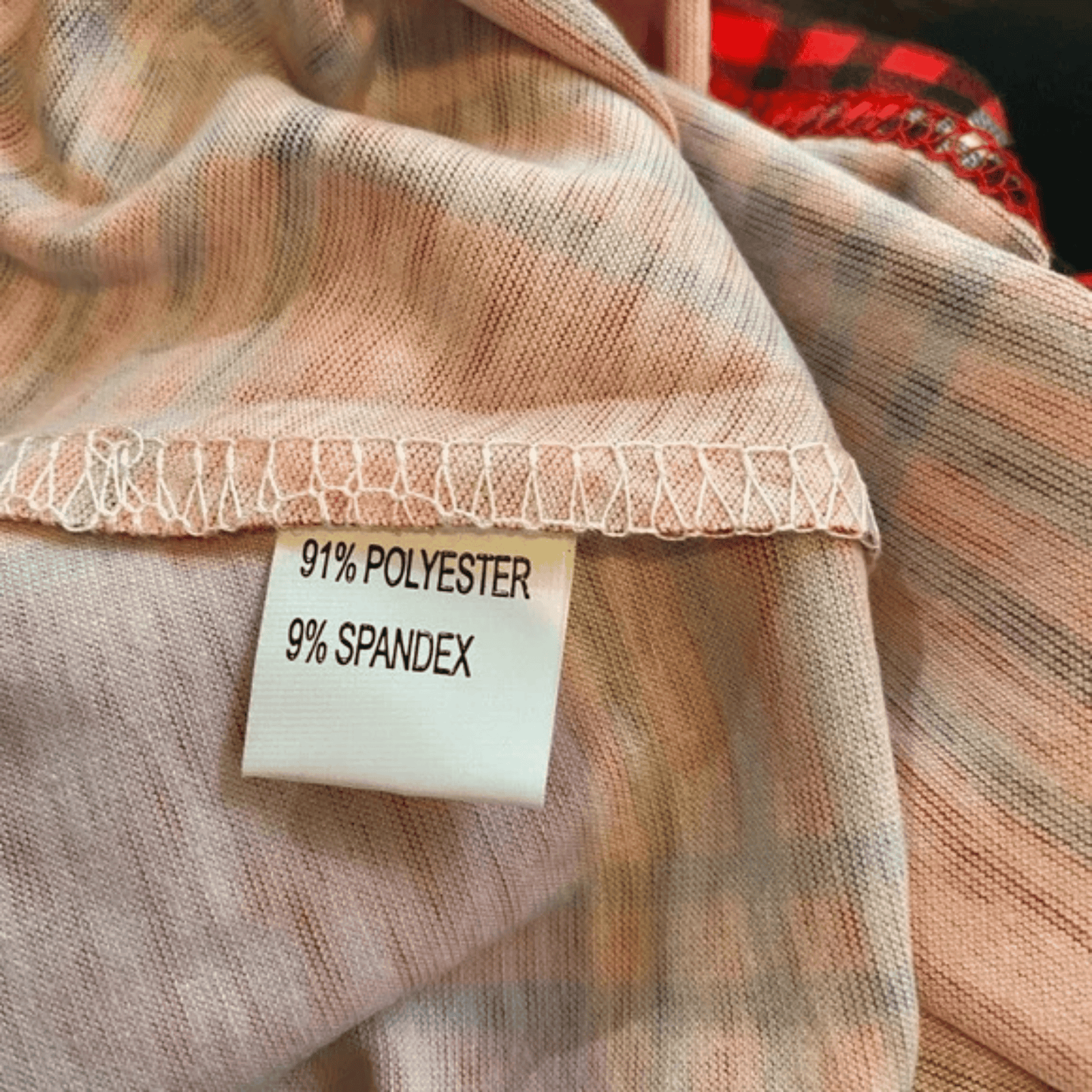 Close-up of fabric with a label indicating 91% polyester and 9% spandex.