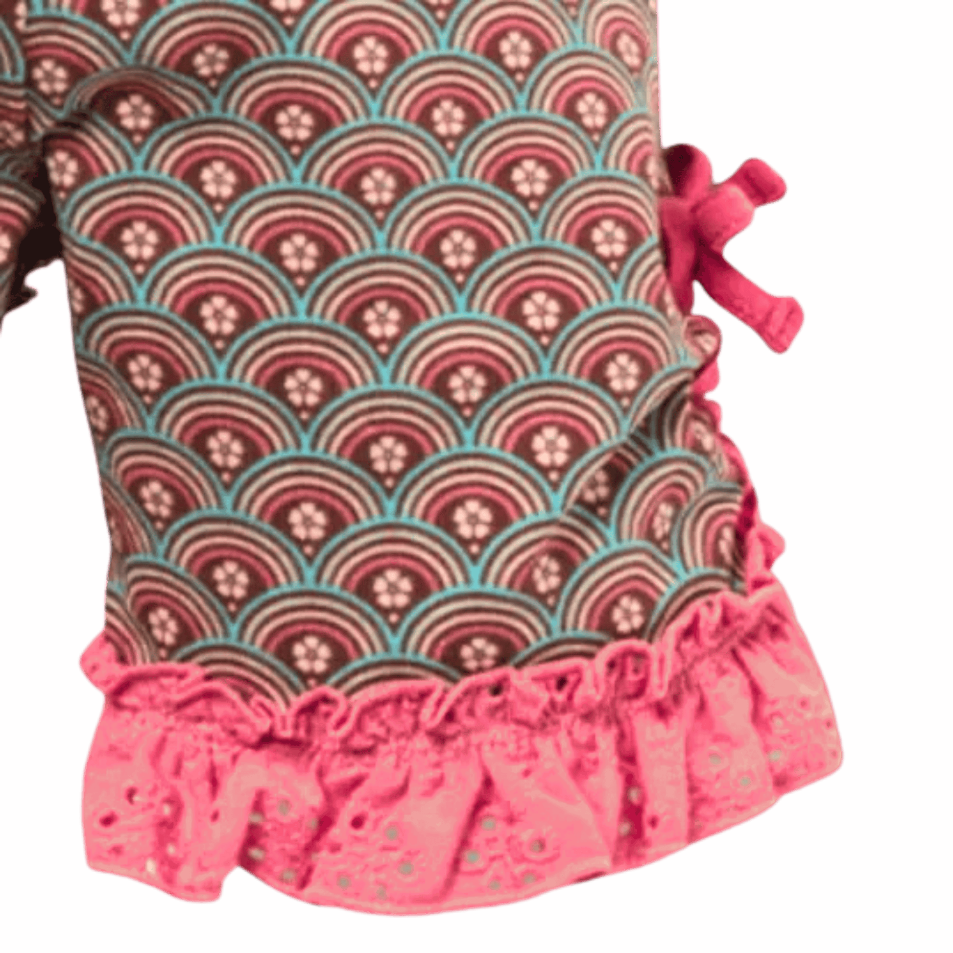 Patterned dress with ruffled hem on a pink background