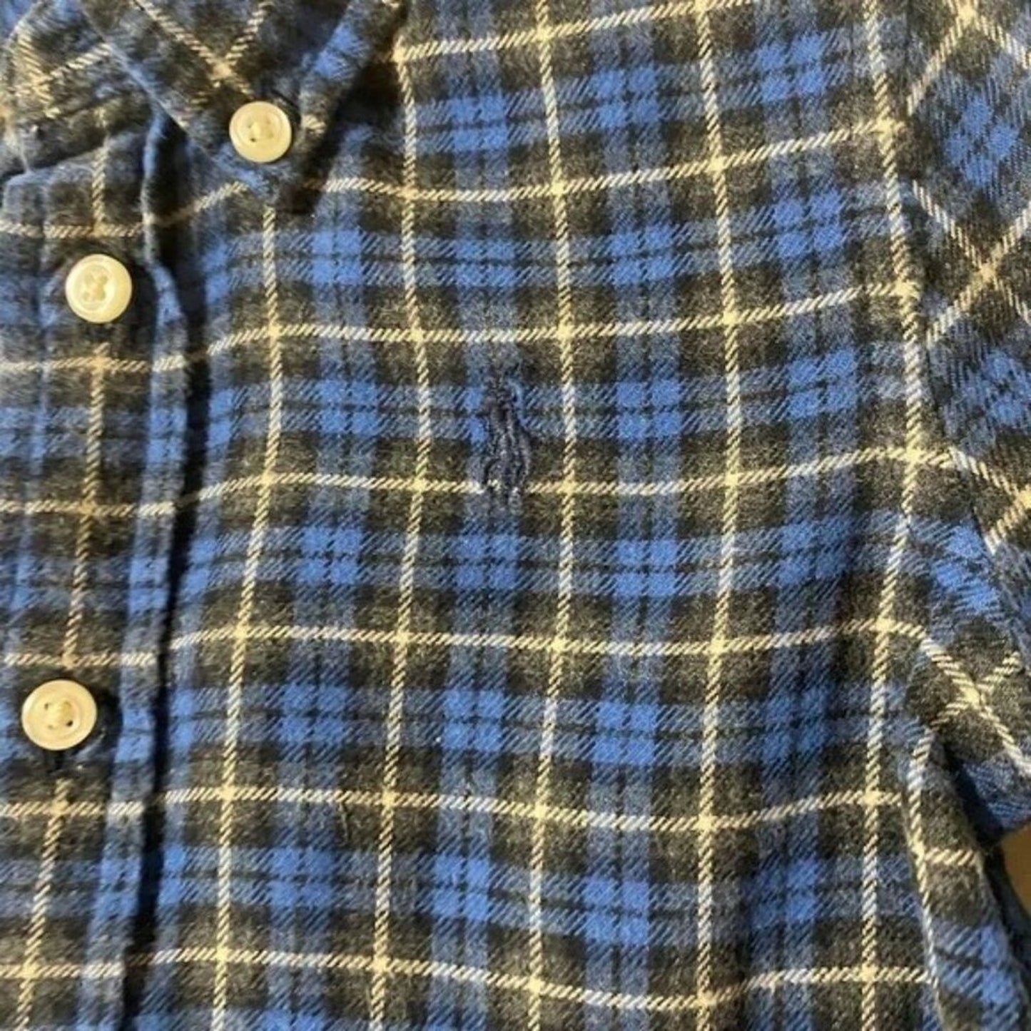 Plaid shirt with buttons on a plain background