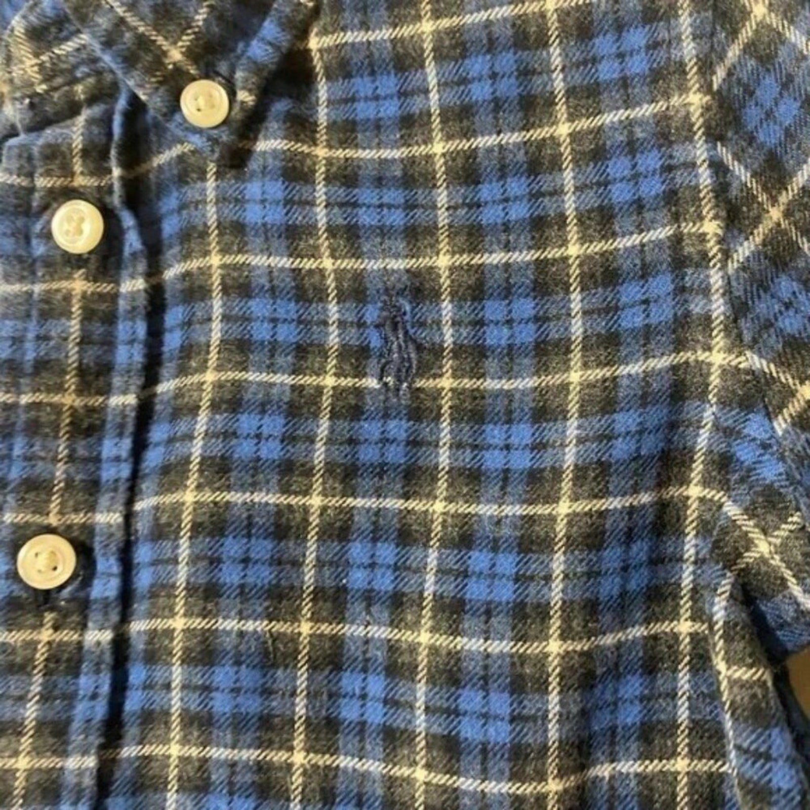 Plaid shirt with buttons on a plain background