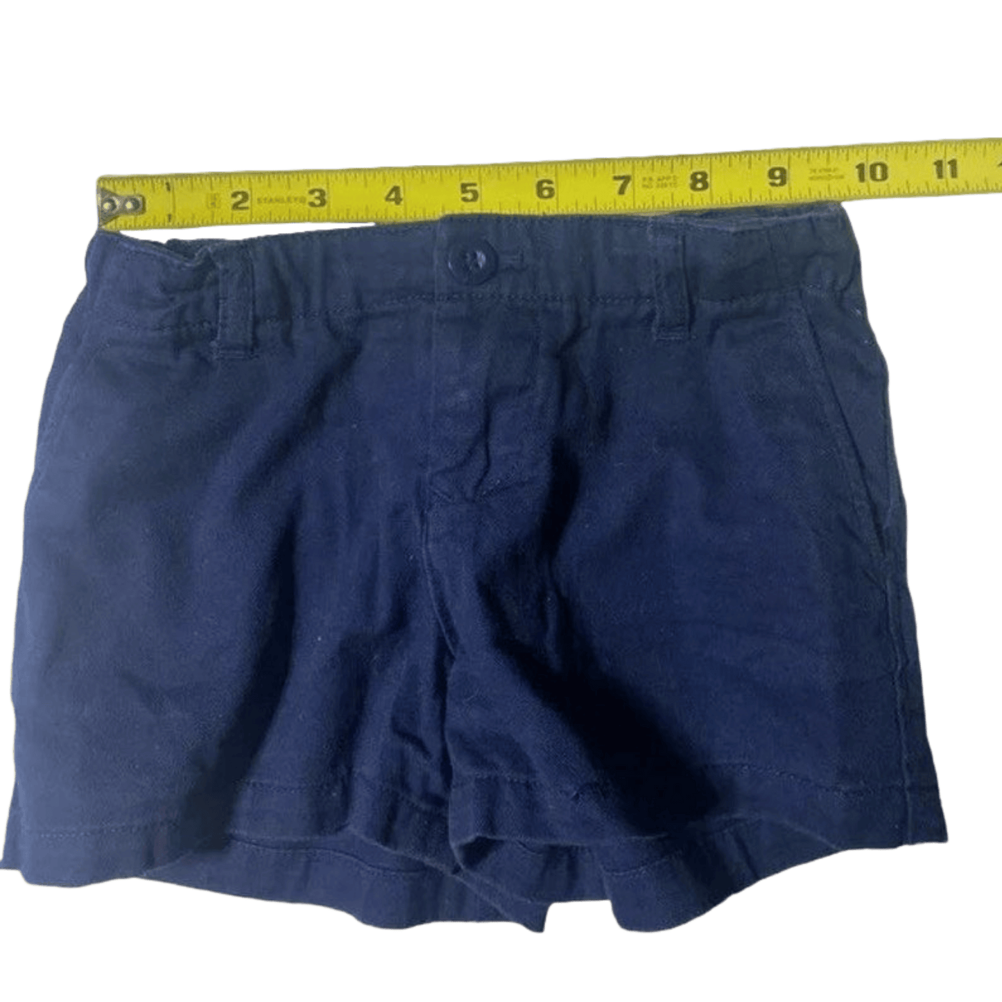 Navy blue shorts with a measuring tape on a transparent background