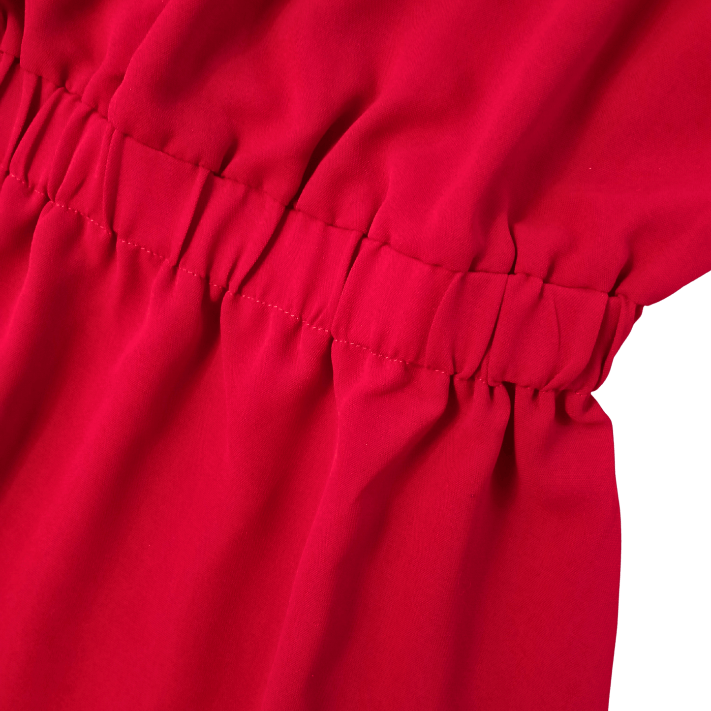 Close-up of a red fabric with pleated texture on a green background