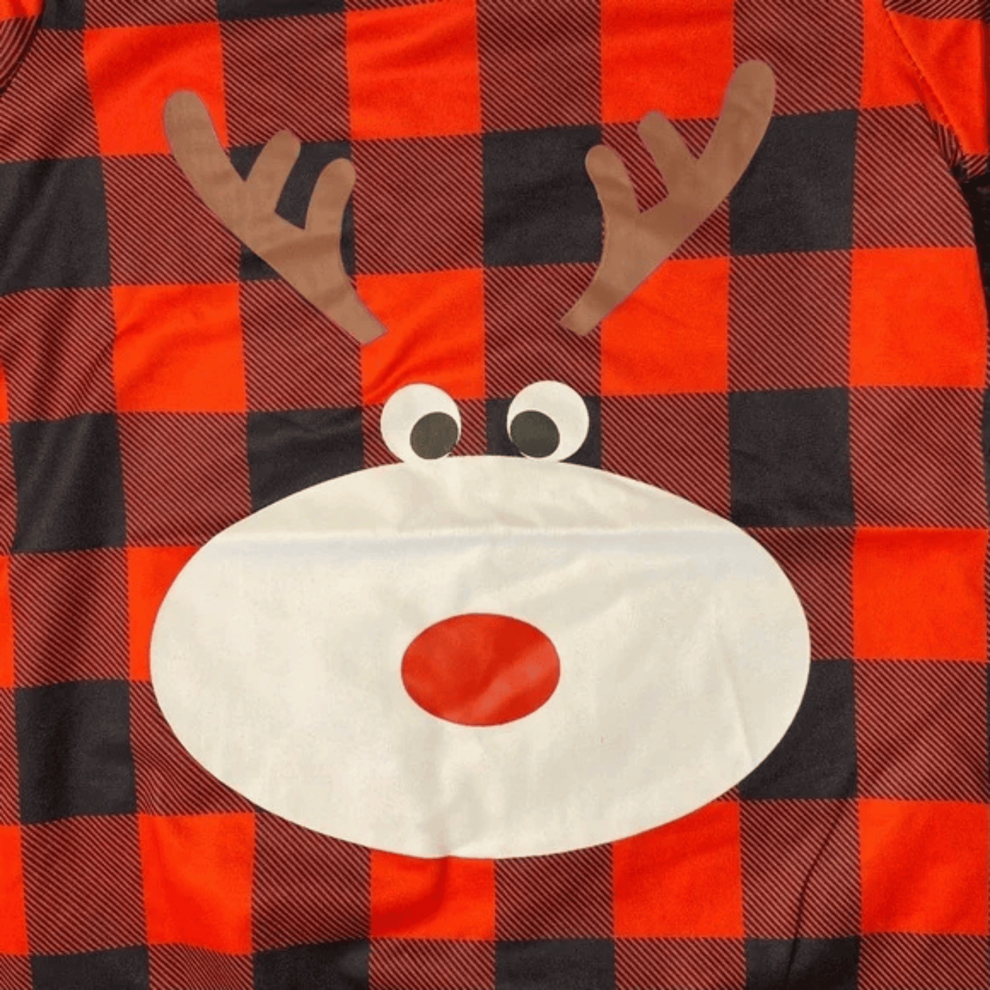 Plaid fabric with a reindeer face design featuring antlers and a red nose.