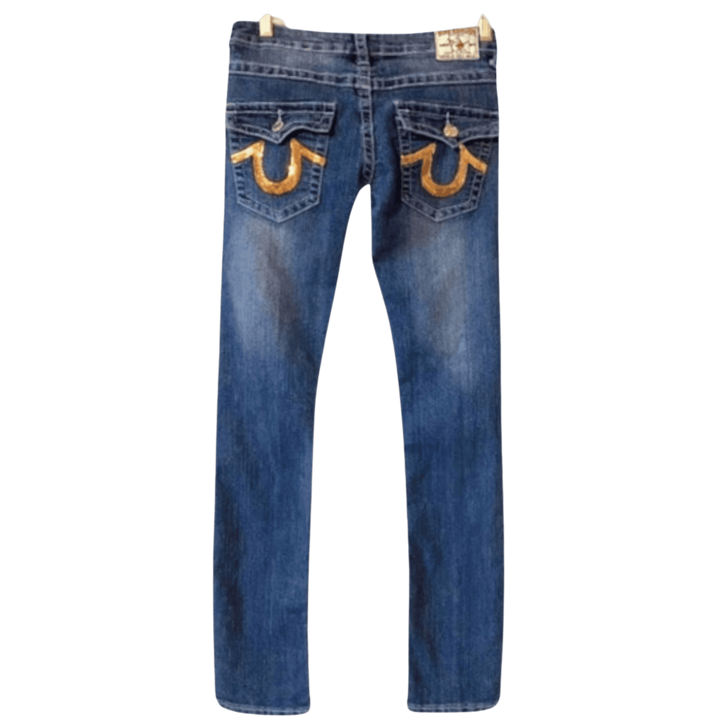 Blue jeans with gold horse shoe designs on the pockets against a transparent background