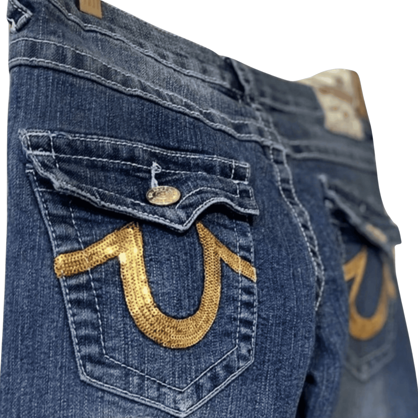 Close-up of blue jeans with gold horseshoe design on a transparent background