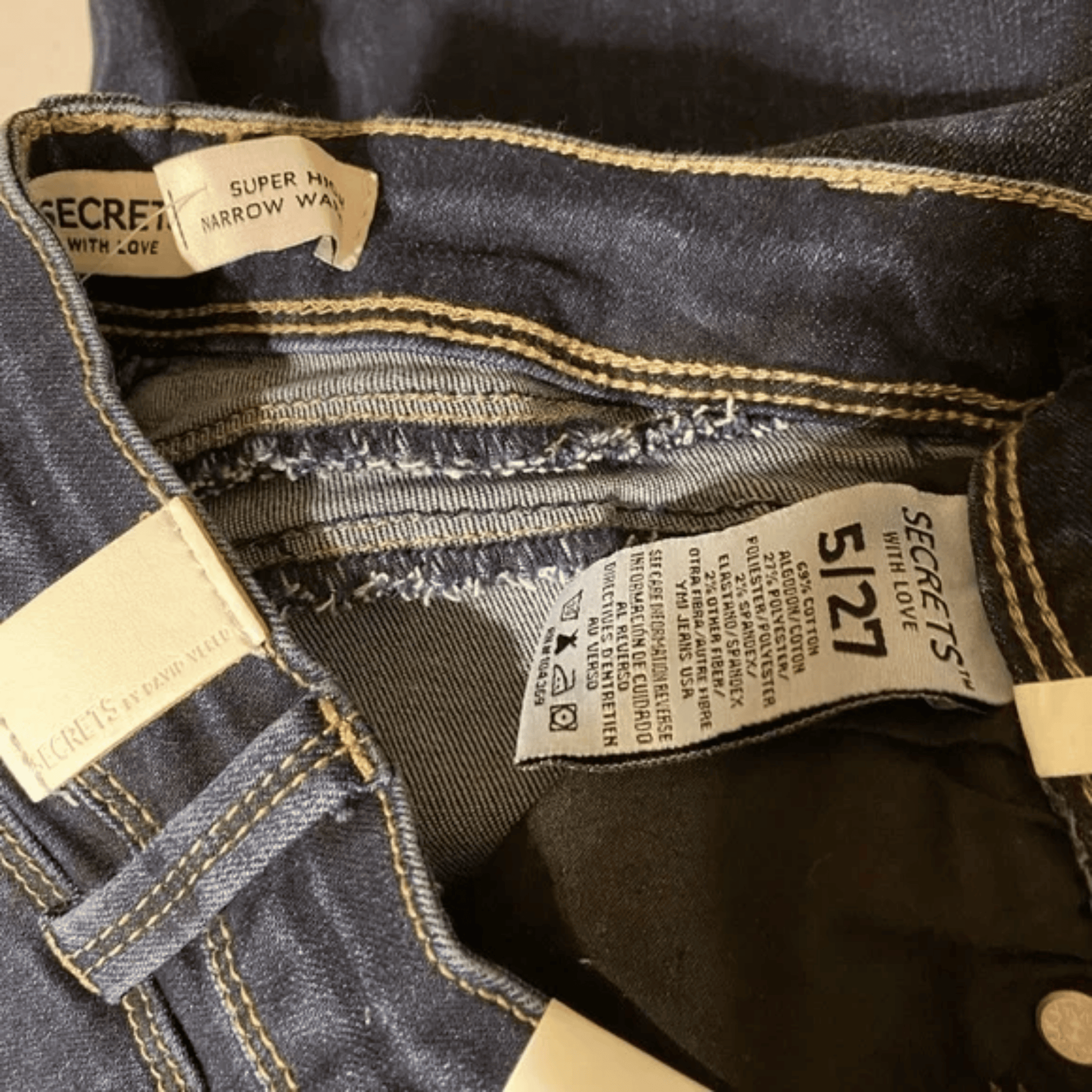 Close-up of denim jeans with brand labels and stitching details.