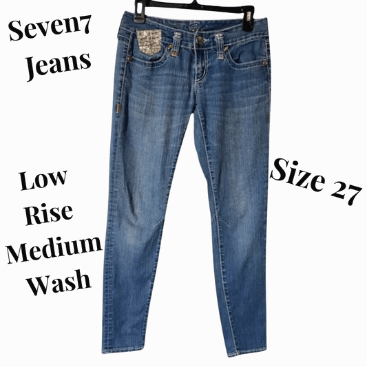 Blue jeans with 'Seven7 Jeans' branding on a gray background