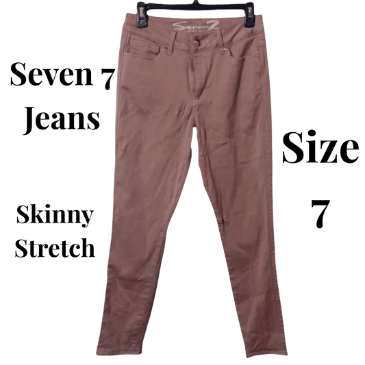 Brown skinny stretch jeans on a hanger with 'Seven 7 Jeans' branding.