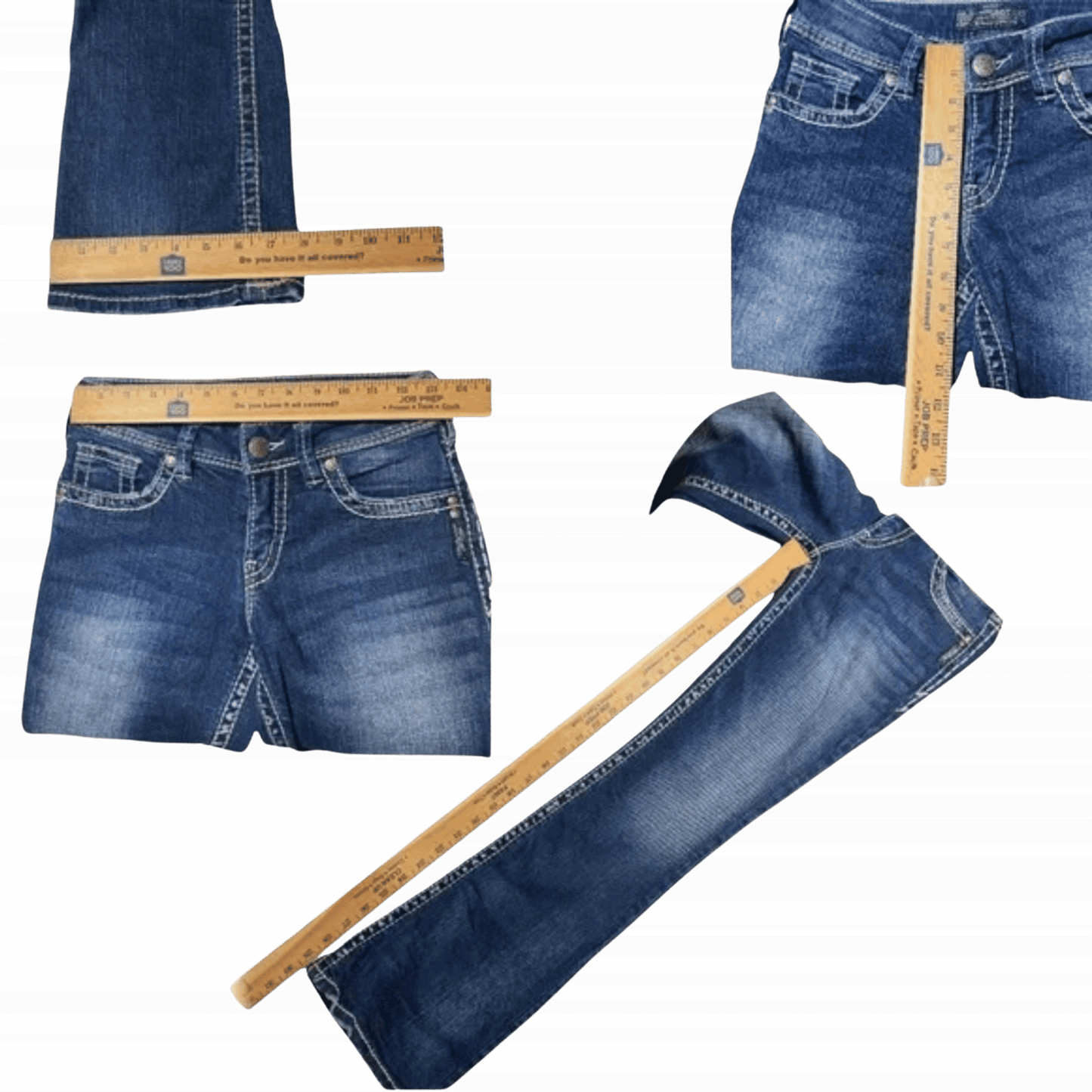 Blue jeans with a measuring tape on a green and black striped background