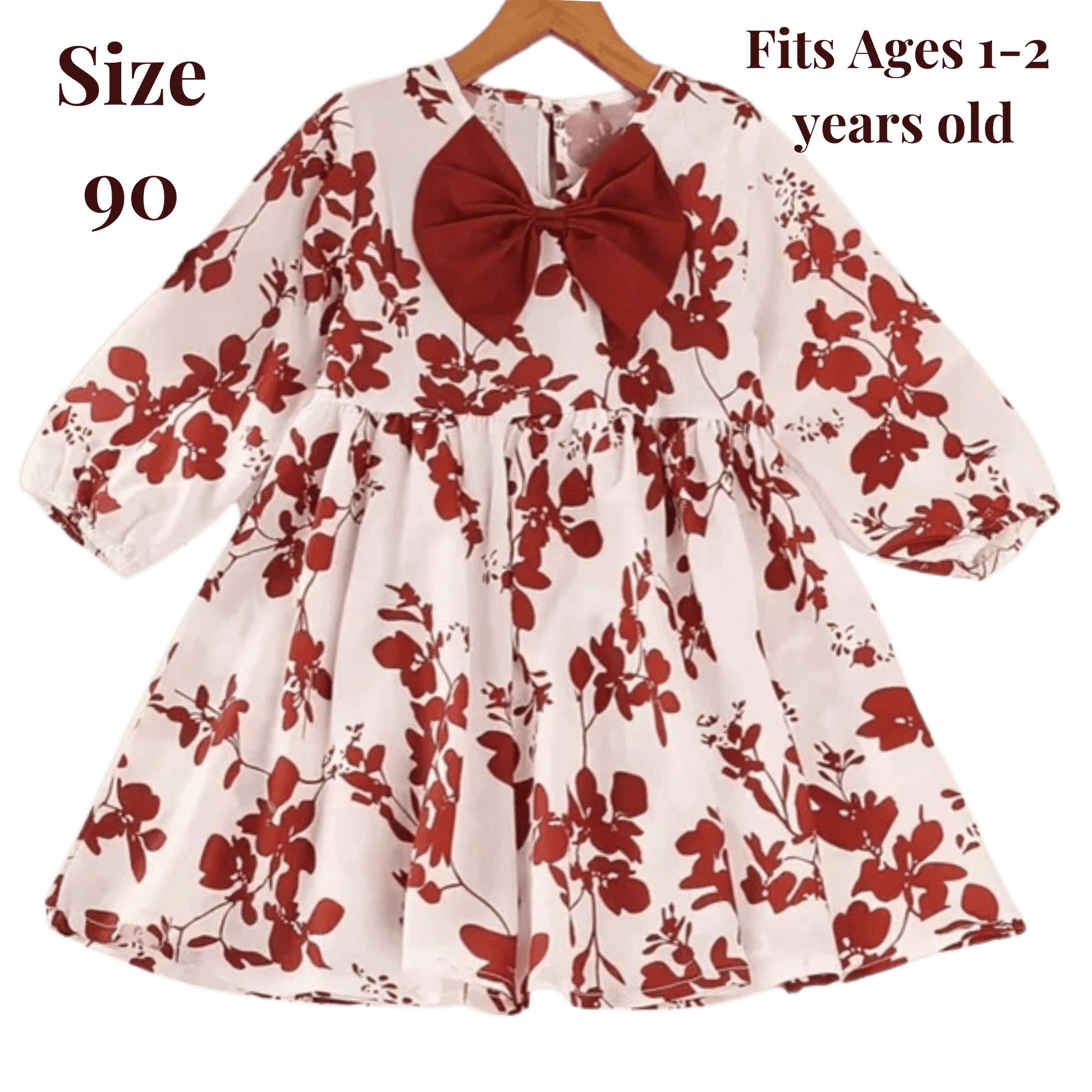 Floral dress with a red bow on a hanger against a green background