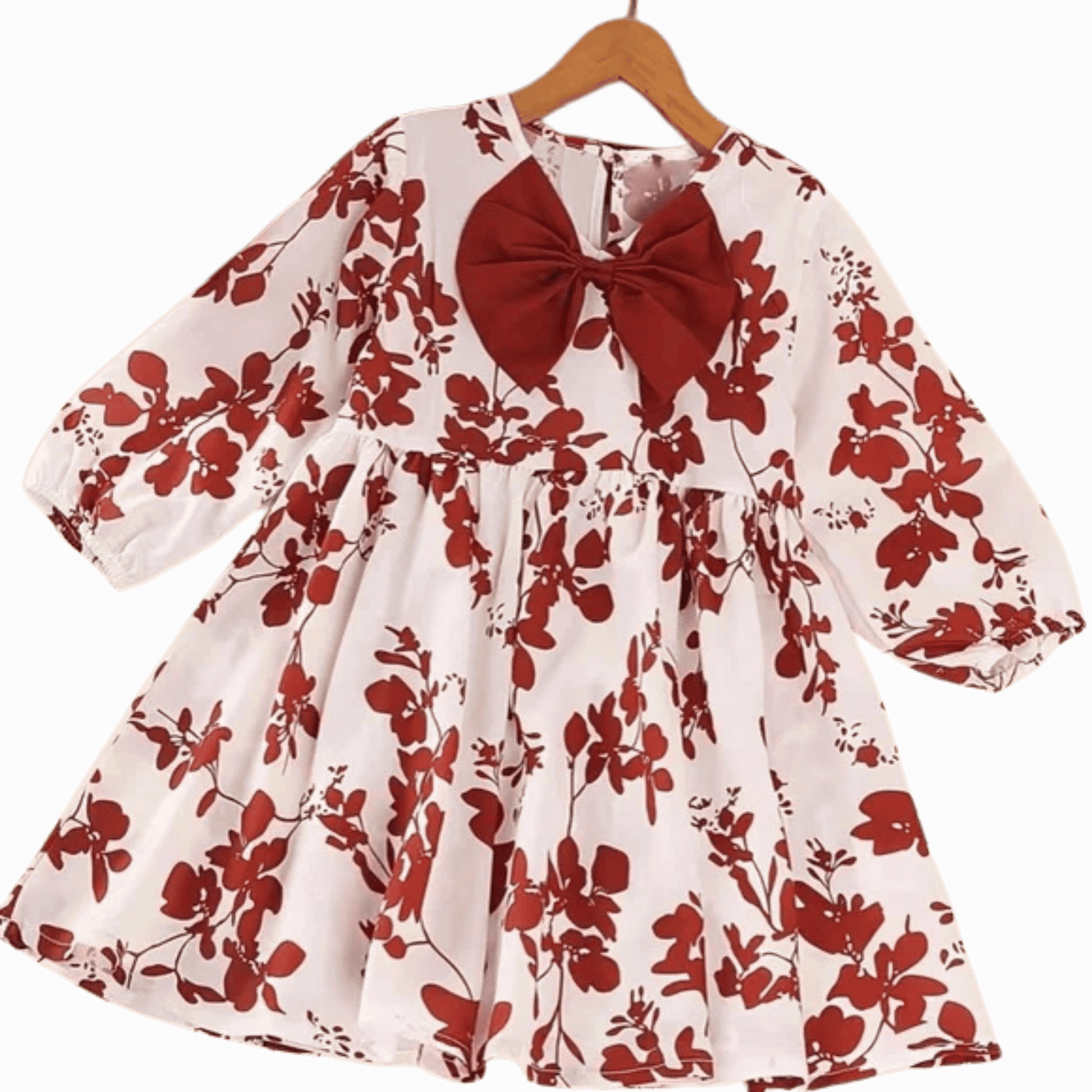 White dress with red floral pattern and large red bow on a hanger against a dark red background
