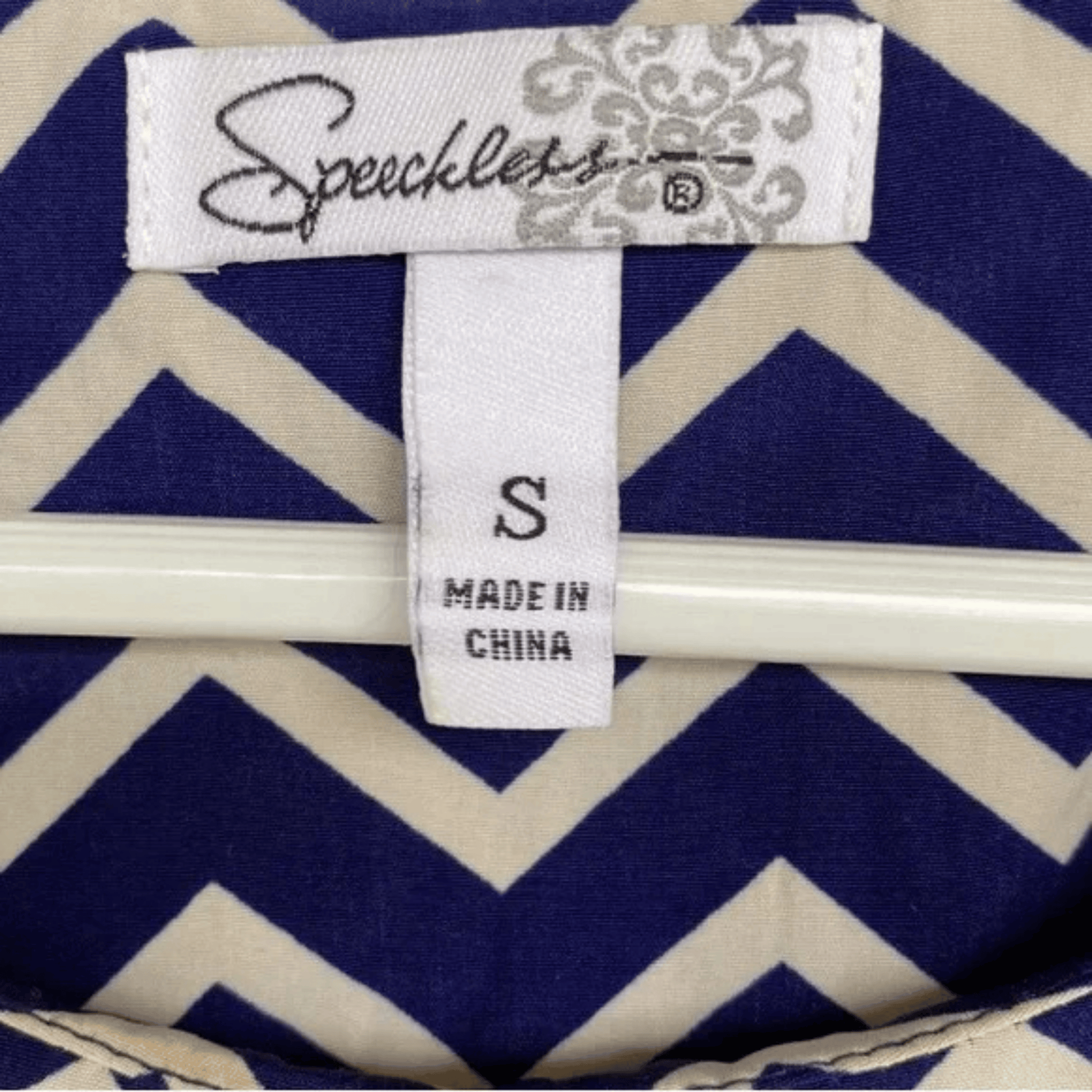 Clothing tag on a garment with blue and white zigzag pattern