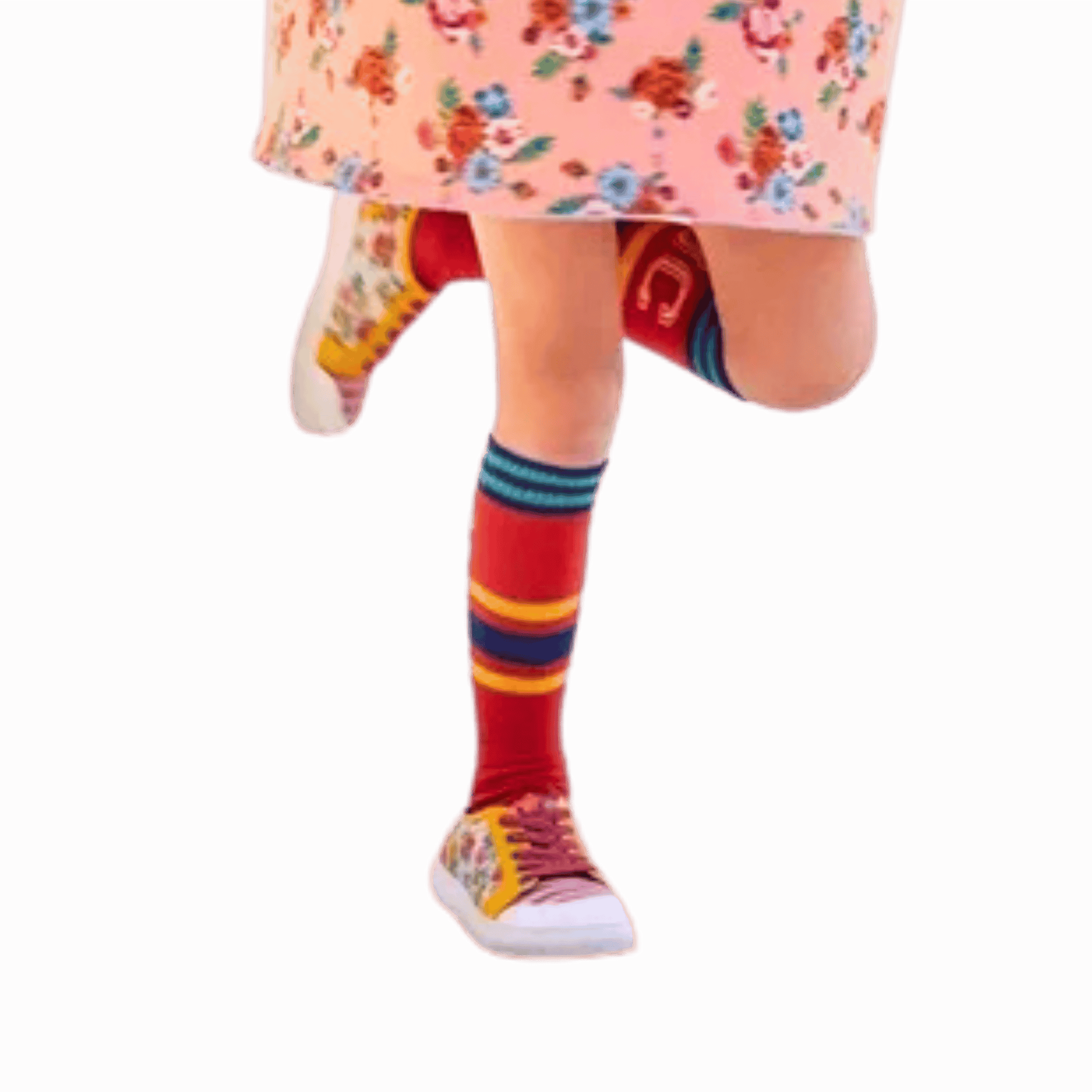 Colorful striped socks worn with a floral dress and sneakers on a red background