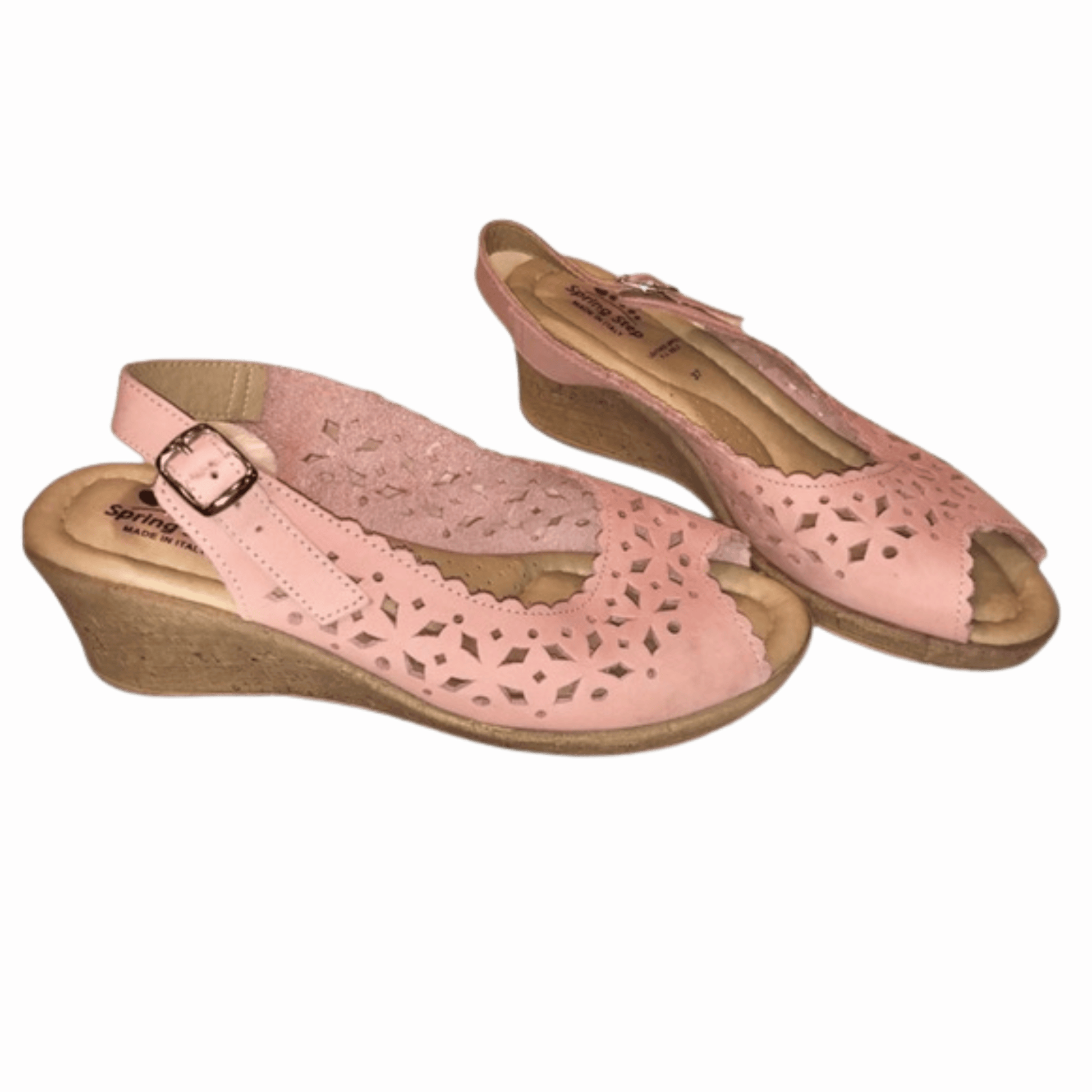 Pair of pink sandals with wooden soles on a red background