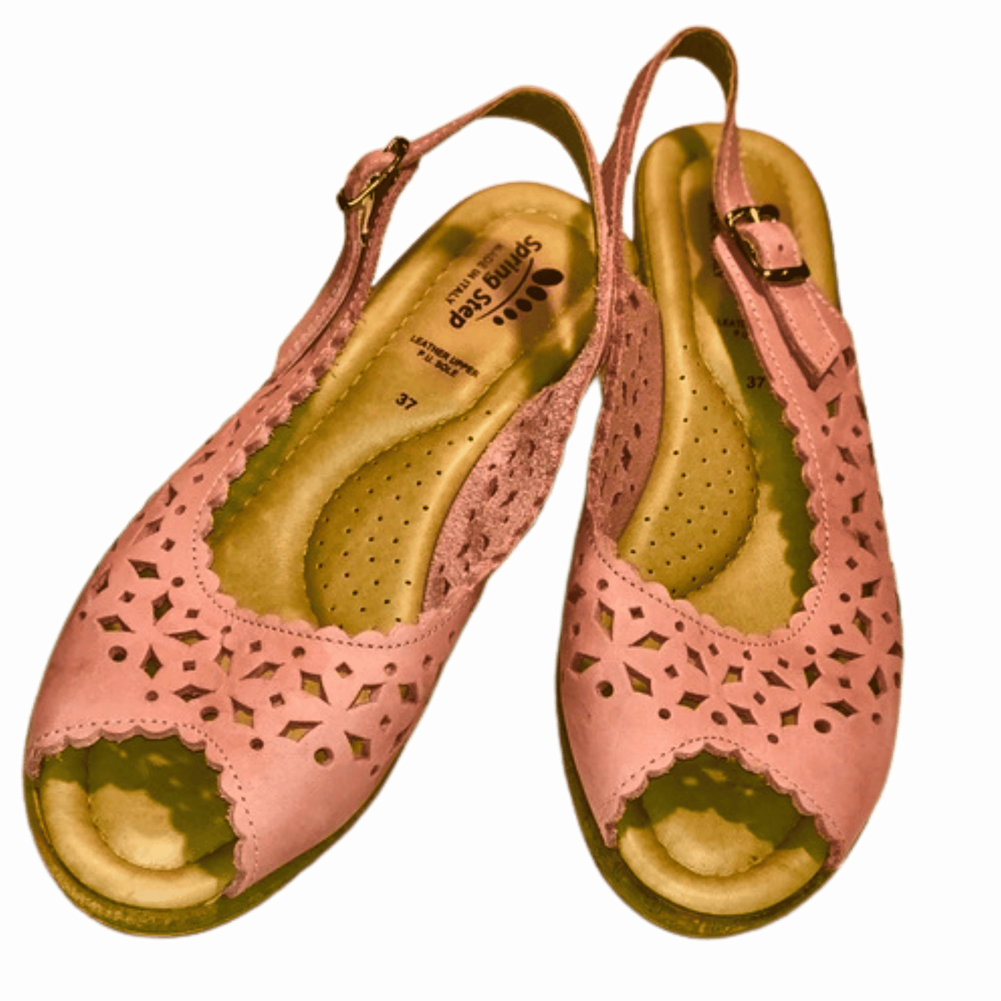 Pair of pink sandals with cut-out design on a blue background