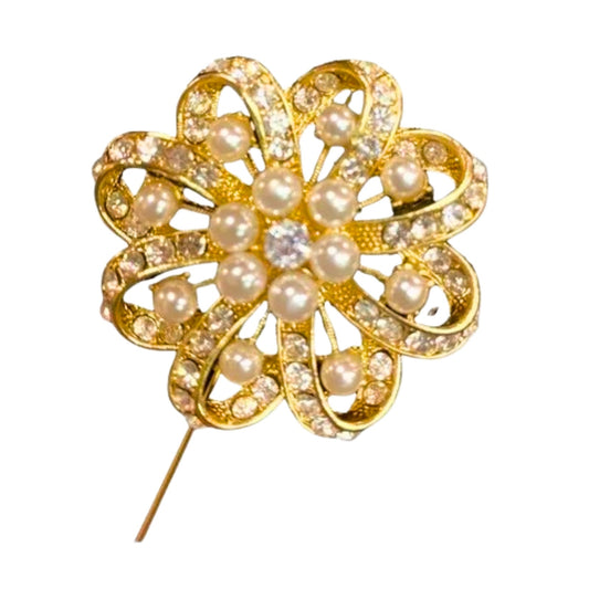 Gold brooch with pearls on a white background