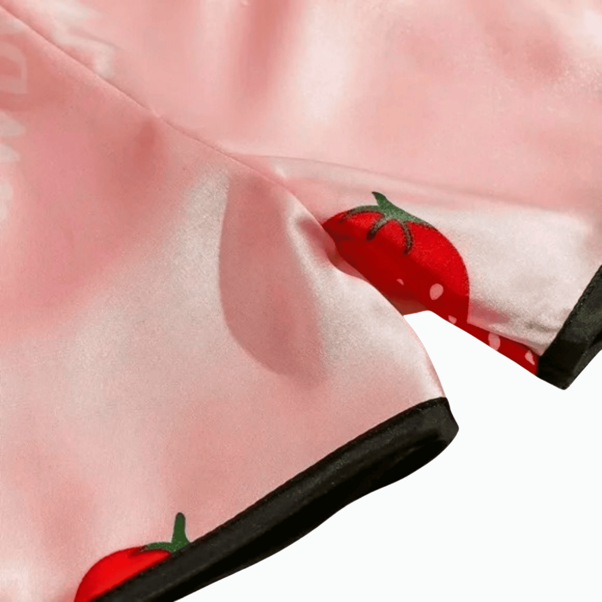 Pink shoe with red strawberry design on a light pink background