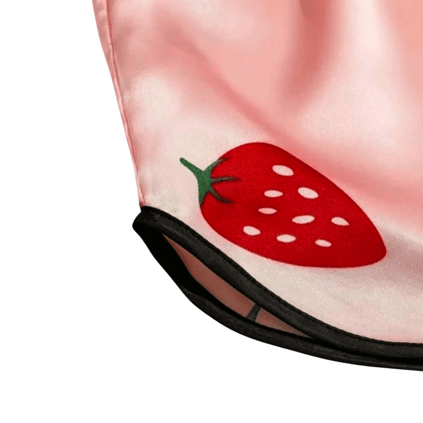Close-up of a pink fabric with a red strawberry design on a green background