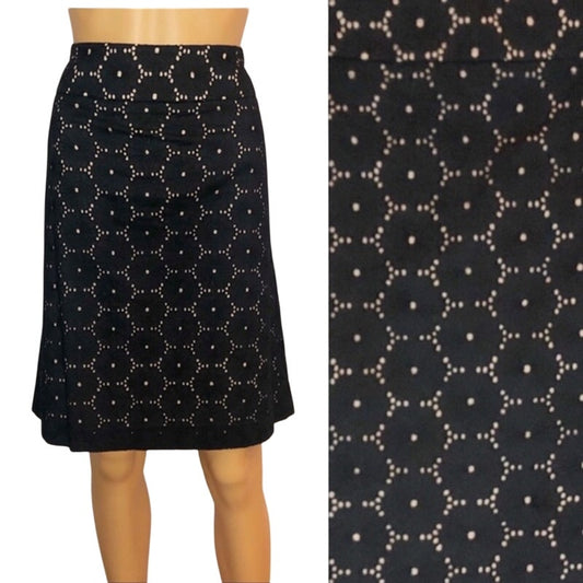 Black skirt with white floral pattern on a mannequin and close-up of the pattern.