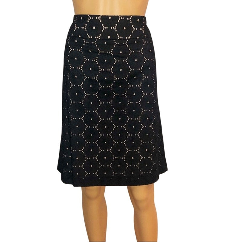 Black skirt with white geometric pattern on a mannequin against a white background