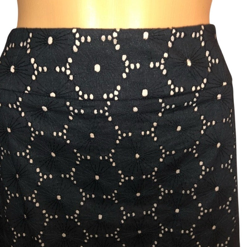 Black skirt with white floral patterns on a white background
