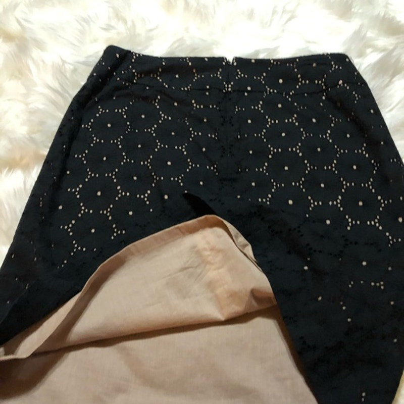 Black leggings with white star pattern on a fluffy white surface