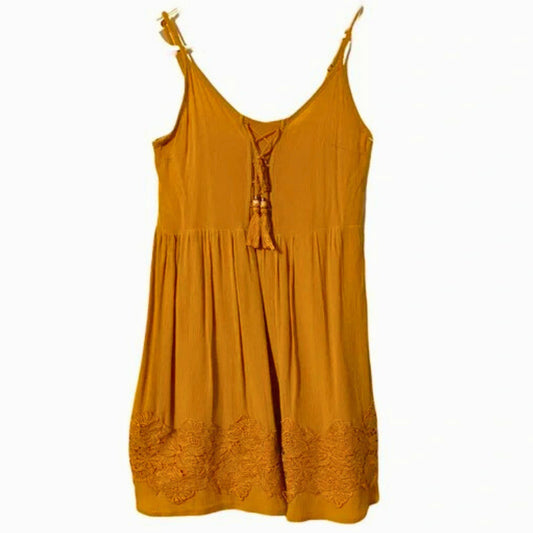 Yellow dress with lace details on a white background