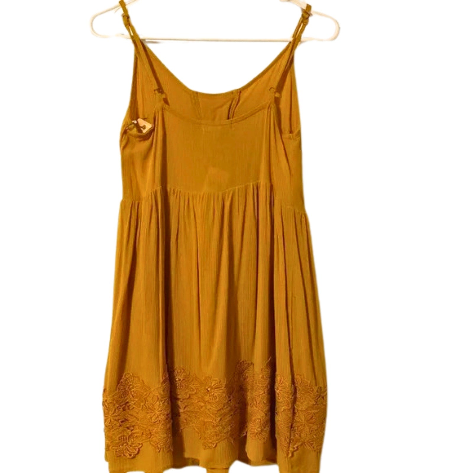 Yellow dress with floral details on a white background